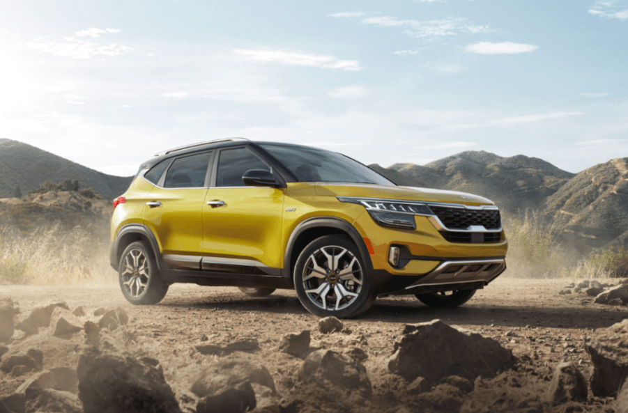 A yellow 2022 Kia Seltos parked in sand