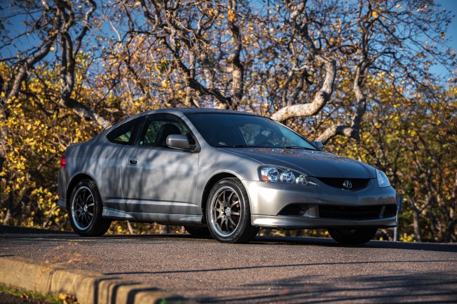 A gray 2006 Acura RSX Type S on a tree-lined road