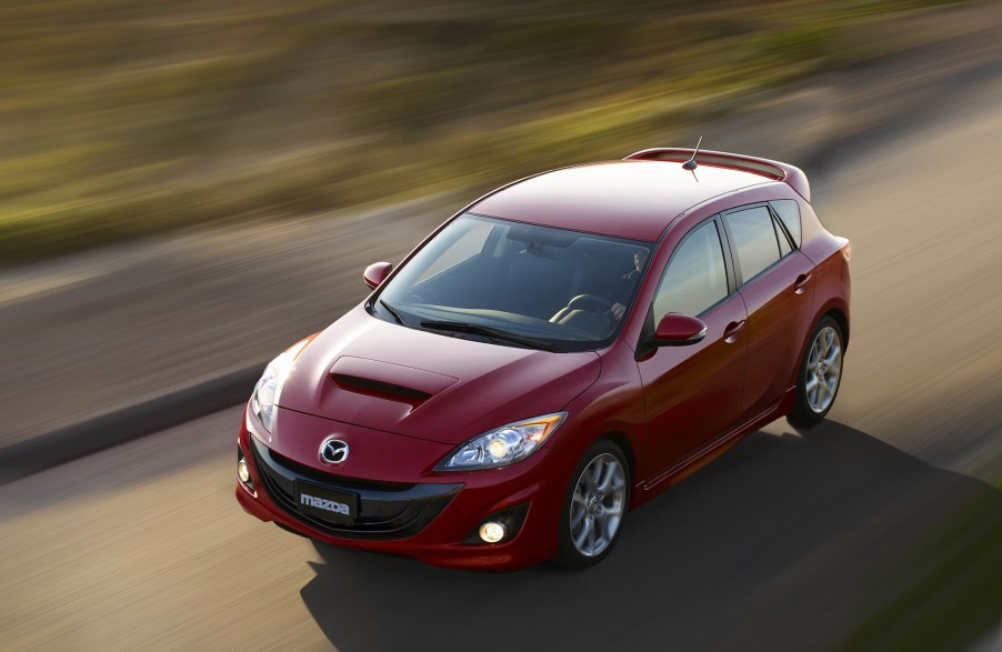 A red 2012 Mazdaspeed 3 photographed from a high angle while driving shows that its the perfect affordable used car that is also a killer sleeper car.