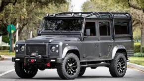 A grey Land Rover defender bulletproof car.