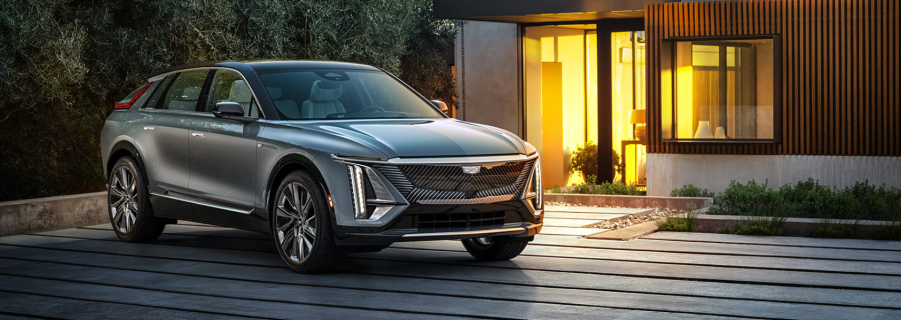 The Cadillac Lyriq EV SUV parked outside a luxury home