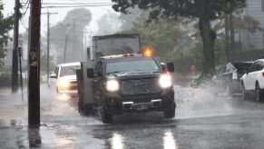 Cars Driving Through Heavy Rain With Hazard Lights On