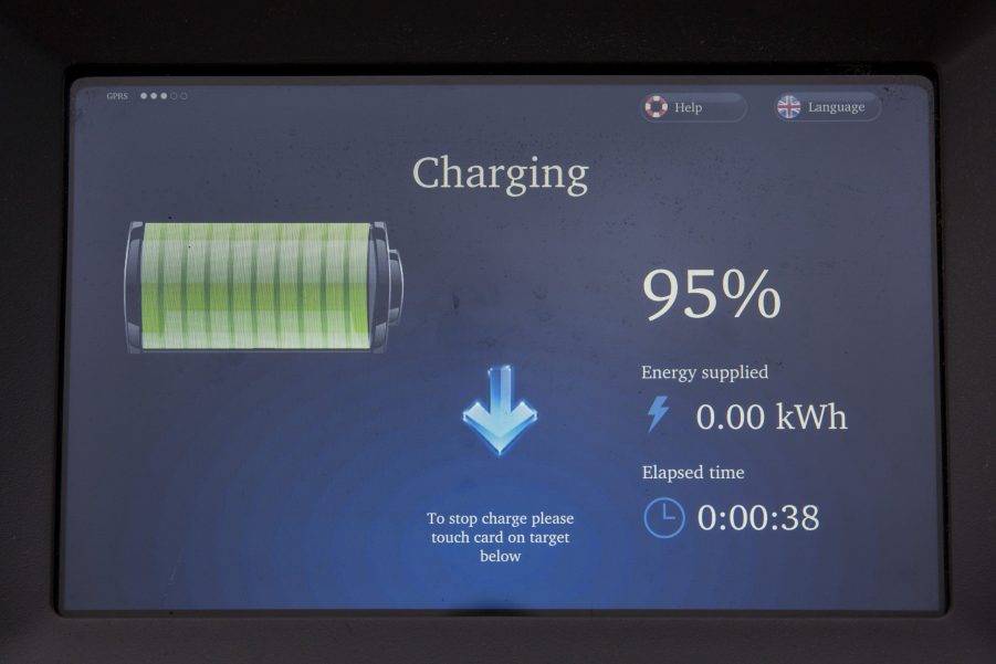 A display shows the predicted EV range for a vehicle plugged in