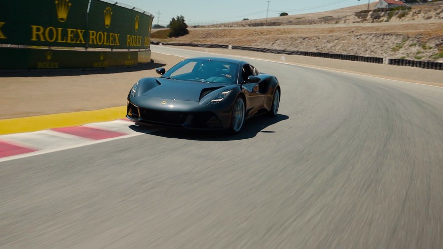 Lotus Emira rounding a corner at Laguna Seca raceway.