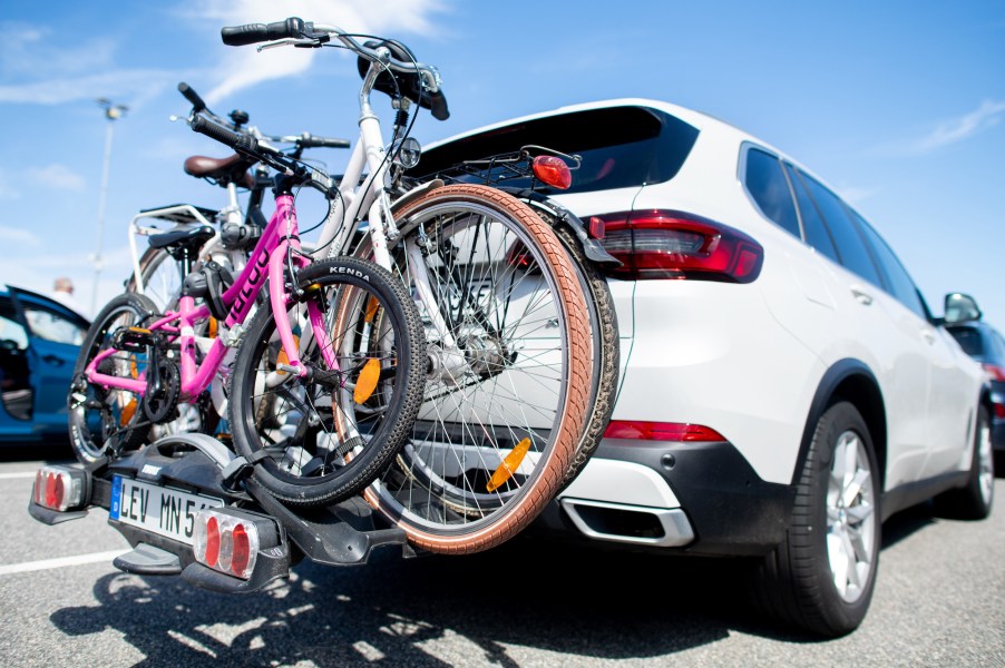 A rear bike rack on a white SUV sitting in traffic