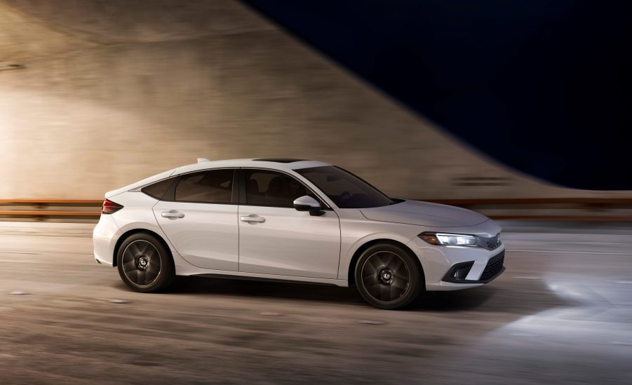 A white 2022 Honda Civic hatch photographed in a tunnel, shot in profile