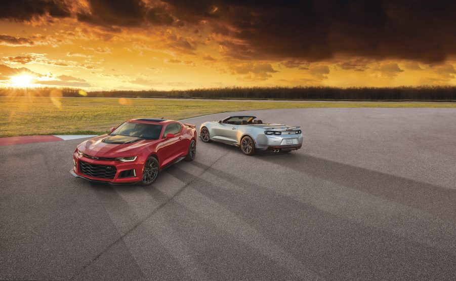 A pair of Chevy Camaros at sunset