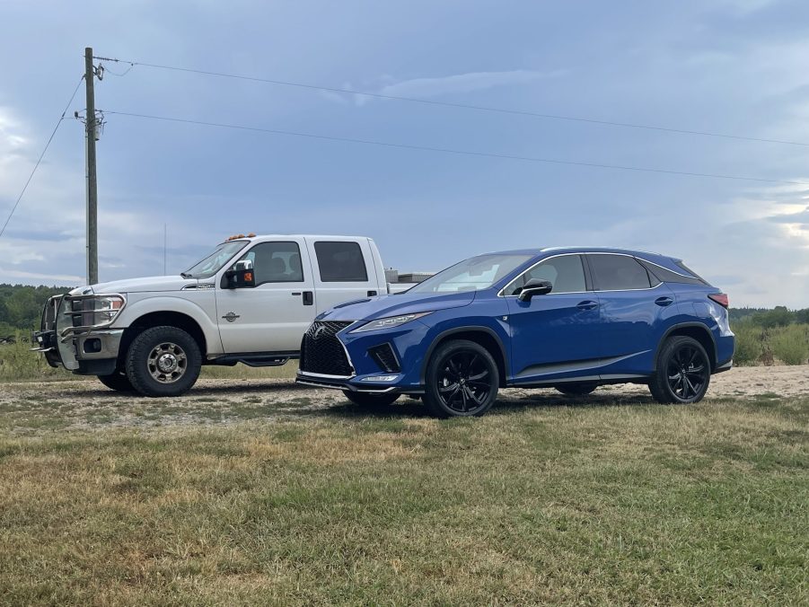 The 2021 Lexus RX 350 F Sport near a Ford F-350