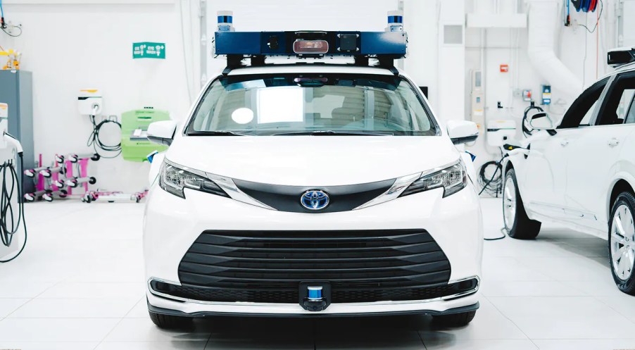 Front view of white Aurora Toyota Sienna self-driving taxi