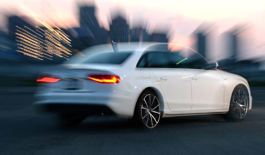 A white 2018 Audi S4 blurred out as it slides across the tarmac