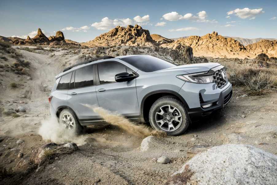 Gray 2022 Honda Passport TrailSport driving on mountainous terrain