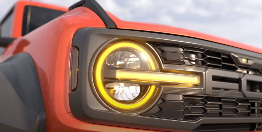 Grille and headlight on orange Ford Bronco Raptor