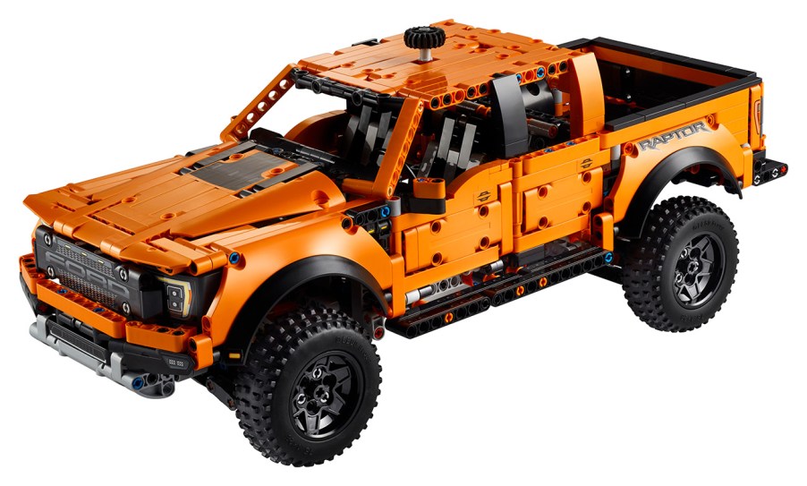 Lego Technic Ford F-150 Raptor set seen in "Code Orange" color and knob attachment at top to allow turning the front wheels.