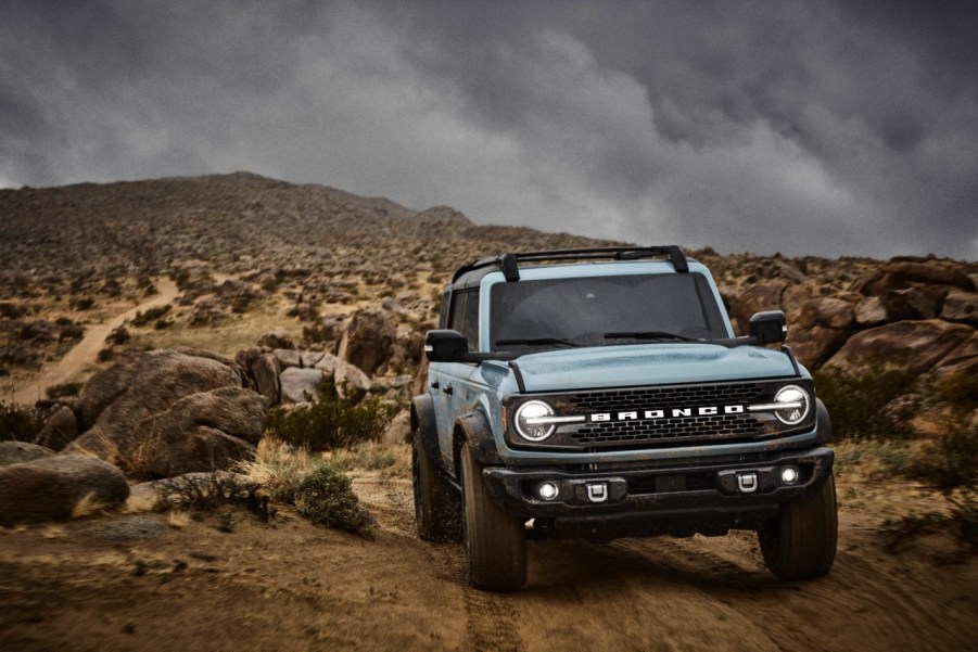 Light blue 2021 Ford Bronco driving on rocky terrain