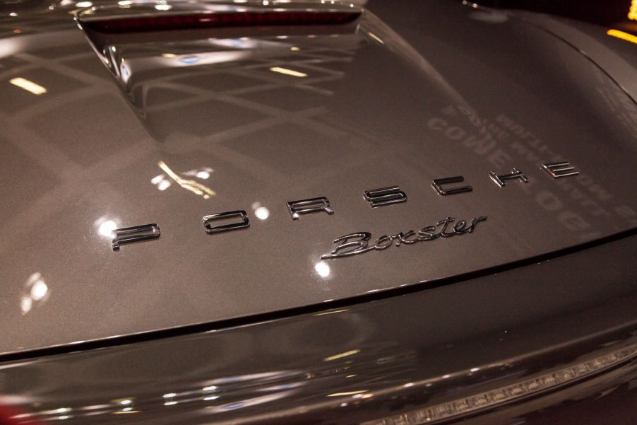 Porsche Boxster logo on a coffee colored car.