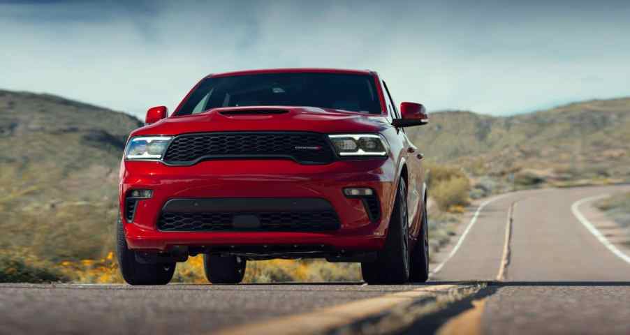 Red 2021 Dodge Durango driving on a desert highway