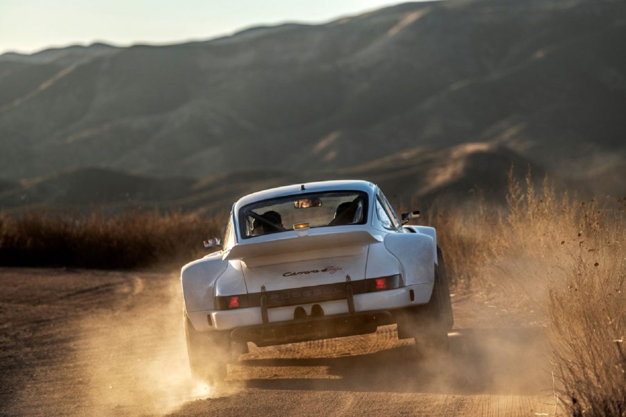 The rear view of a white Russell Built Fabrications Baja 911 sliding in the desert