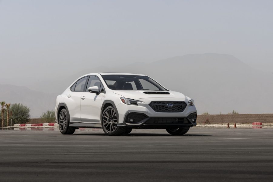 A white 2022 Subaru WRX shot from the front 3/4 on a racetrack