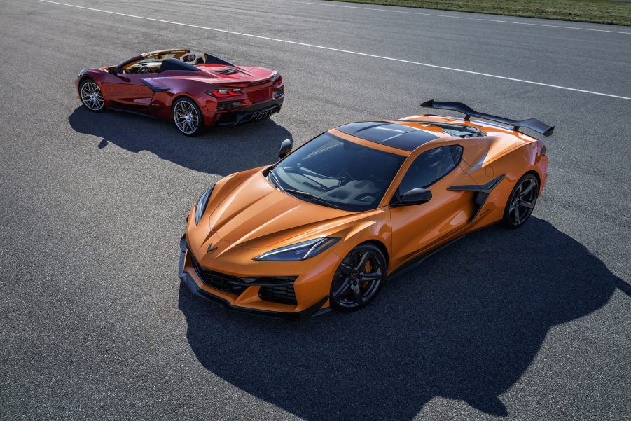 A pair of 2023 Chevrolet Corvette Z06 models, one orange and one red shot from the high 3/4