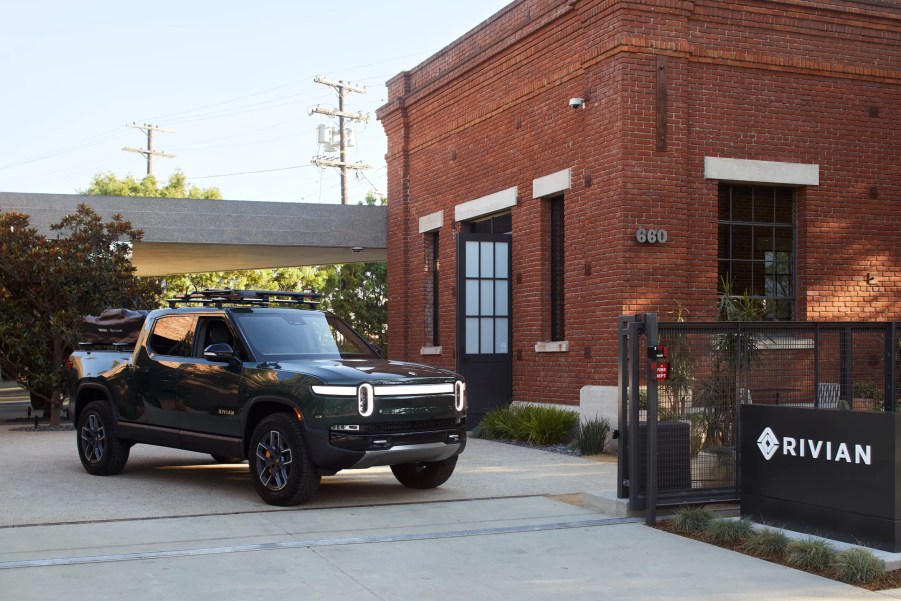 Green Rivian R1T parked next to the Venice Rivian Hub building