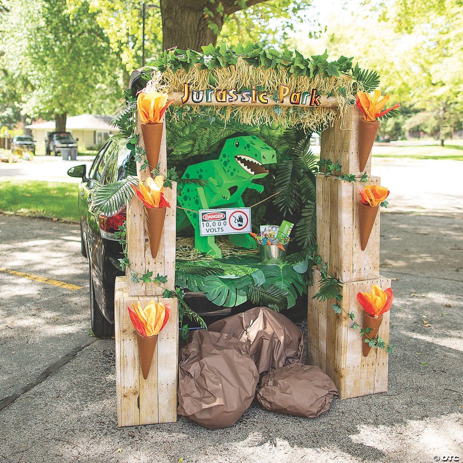 Jurassic Park trunk-or-treat decorations for a car.