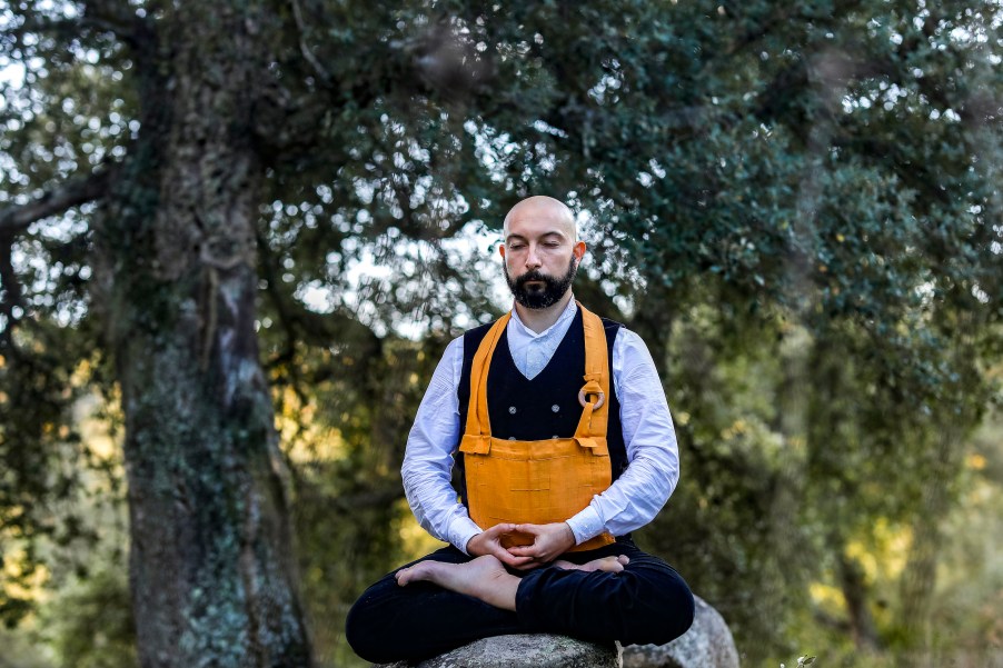 A monk meditating in the woods