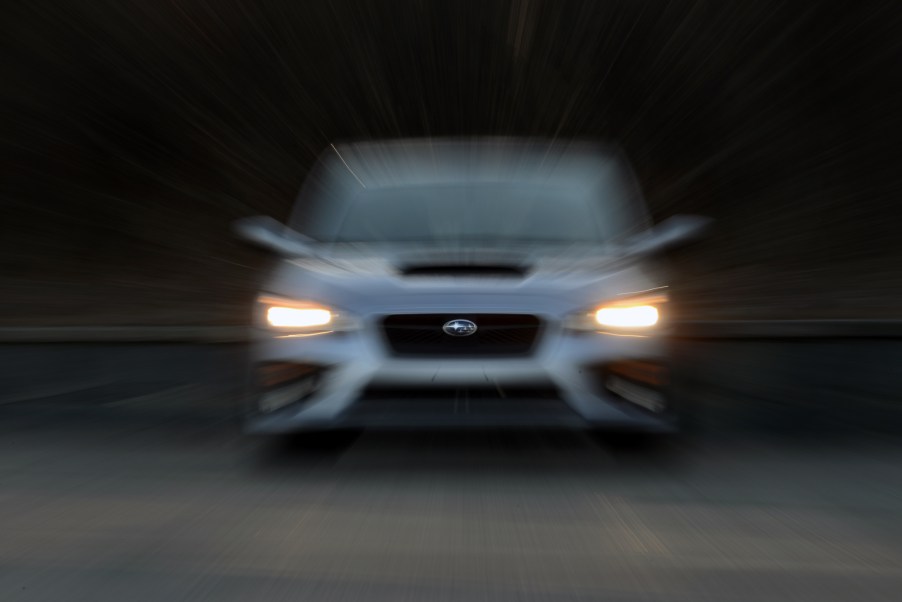 A silver Subaru WRX shot from the front with a blur effect applied to the photo