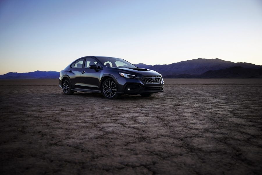 A dark blue 2022 Subaru WRX shot from the front 3/4 on a dry lake bed