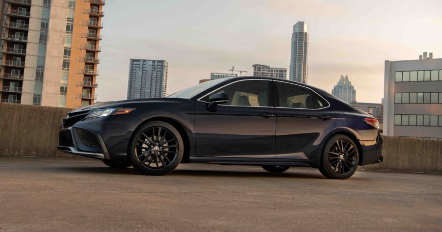 A profile shot of a black 2022 Toyota Camry sedan at sunset