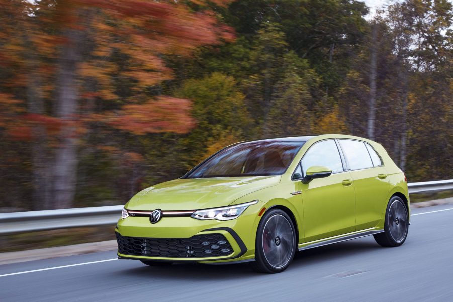 A yellow 2022 Volkswagen GTI shot from the front 3/4 on a country road