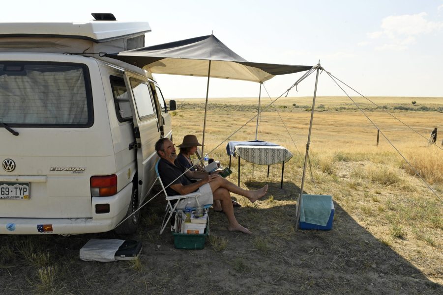 A couple relaxing at an RV campgroundA couple relaxing at an RV campground