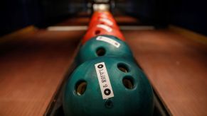 Bowling balls lined up at a bowling alley