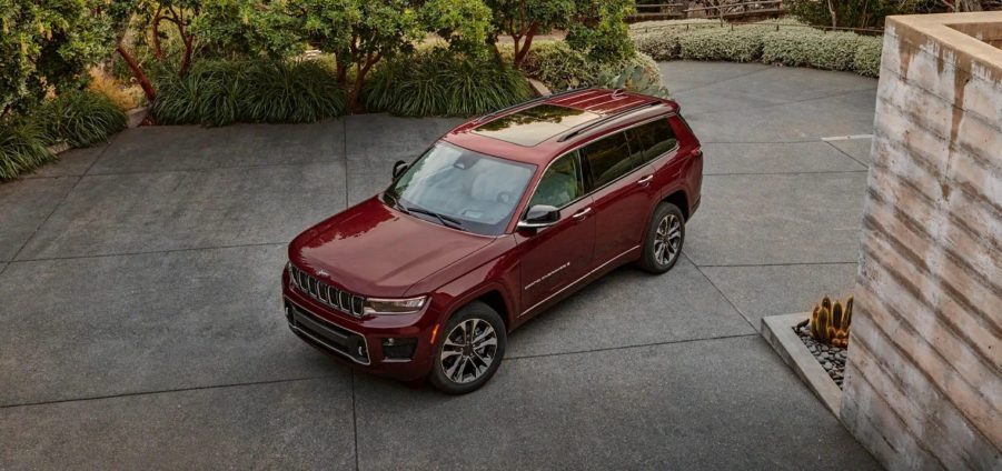 red Jeep Grand Cherokee L in a driveway