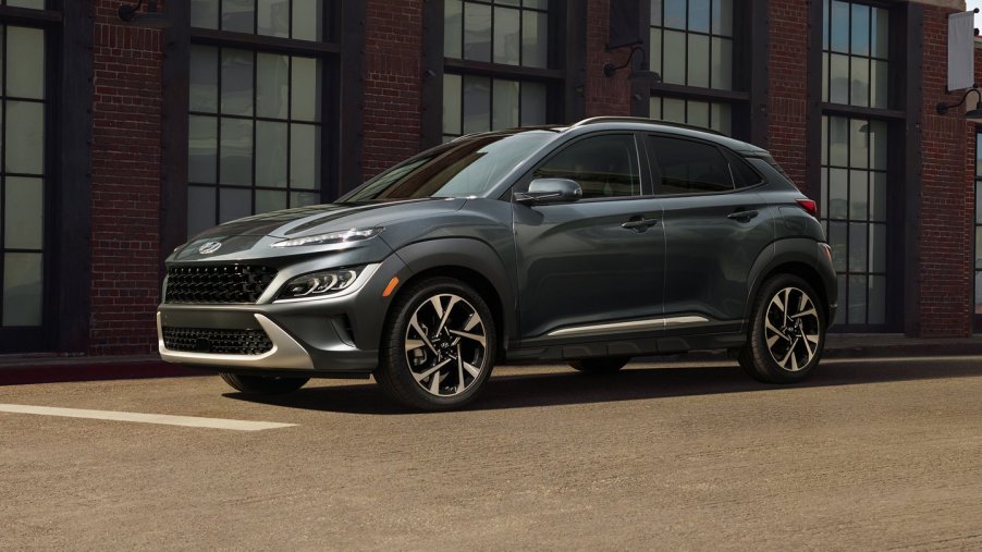 Gray 2022 Hyundai Kona parked next to a brick building