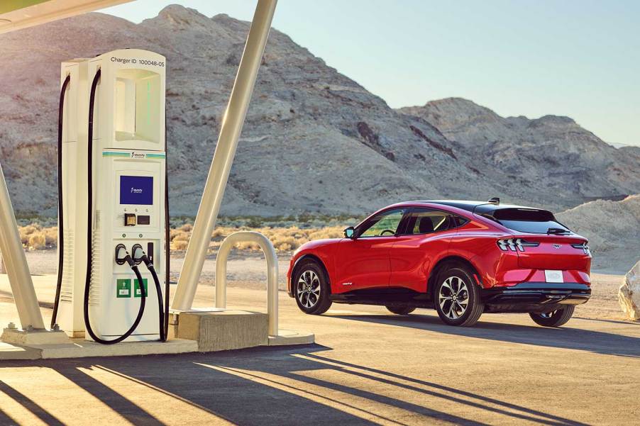 Red 2022 Ford Mustang Mach-E parked next to a charging station