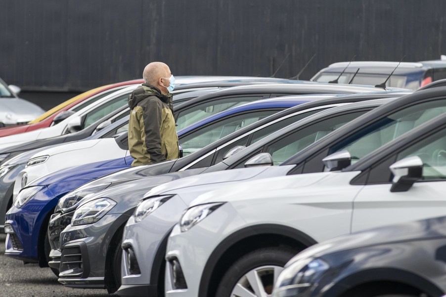 Man walks through car dealership looking for the most satisfying car brand 2021