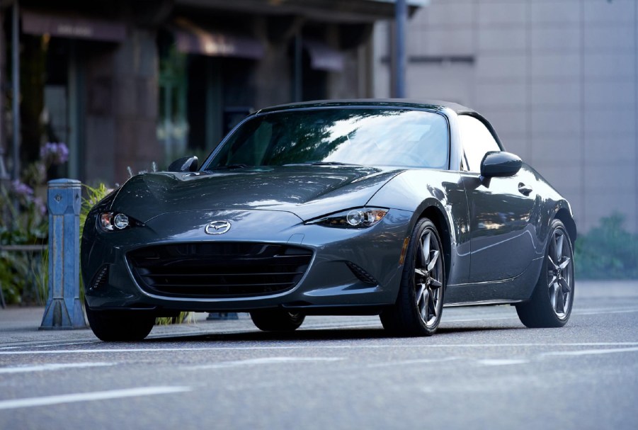 A gray 2021 Mazda MX-5 Miata on a city street