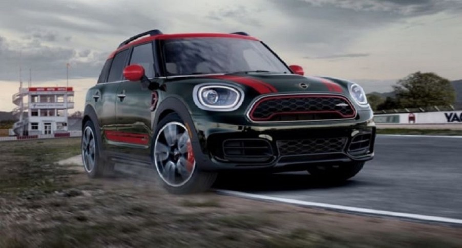 A black and red 2022 Mini Countryman driving down a road.