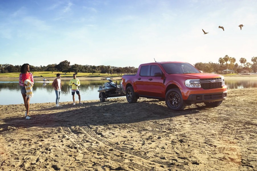 A red 2022 Ford Maverick parked at a beach.