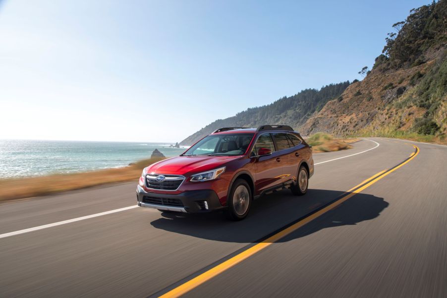 A red Subaru Outback crossover shot from the front 3/4