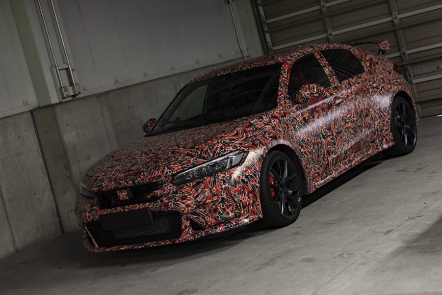 A camouflaged 2023 Honda Civic Type R in a pit lane garage at Suzuka