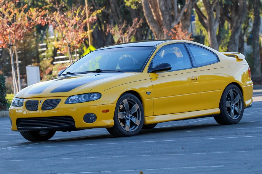 A modified yellow-and-black 2004 Pontiac GTO on a street