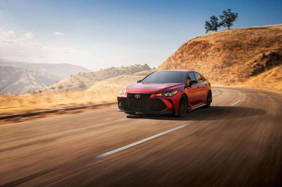 Red 2021 Toyota Avalon TRD driving on a mountain road