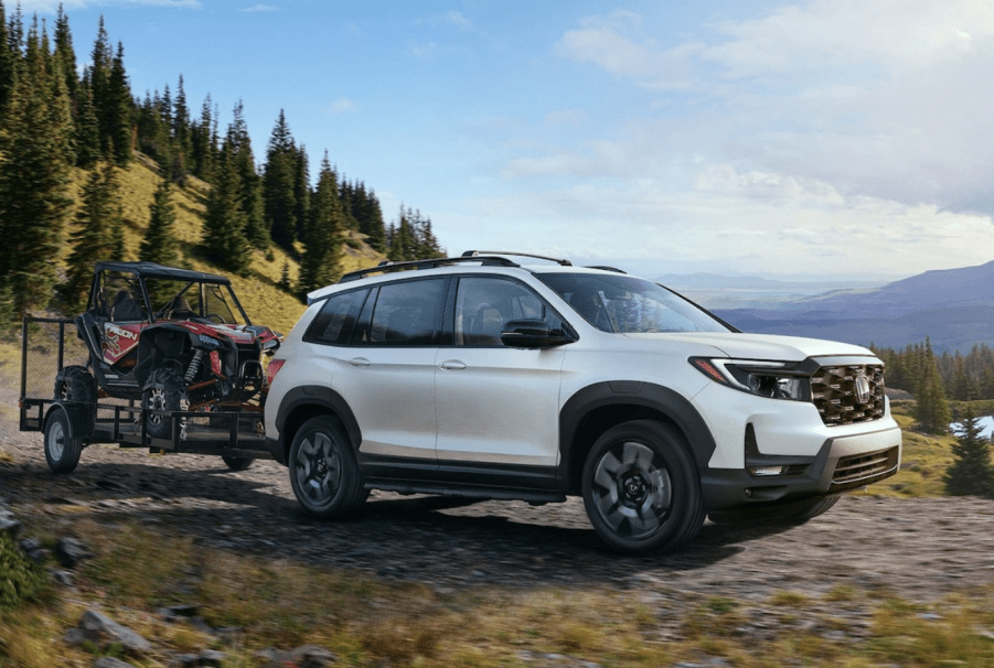 White 2022 Honda Passport Elite towing an ATV