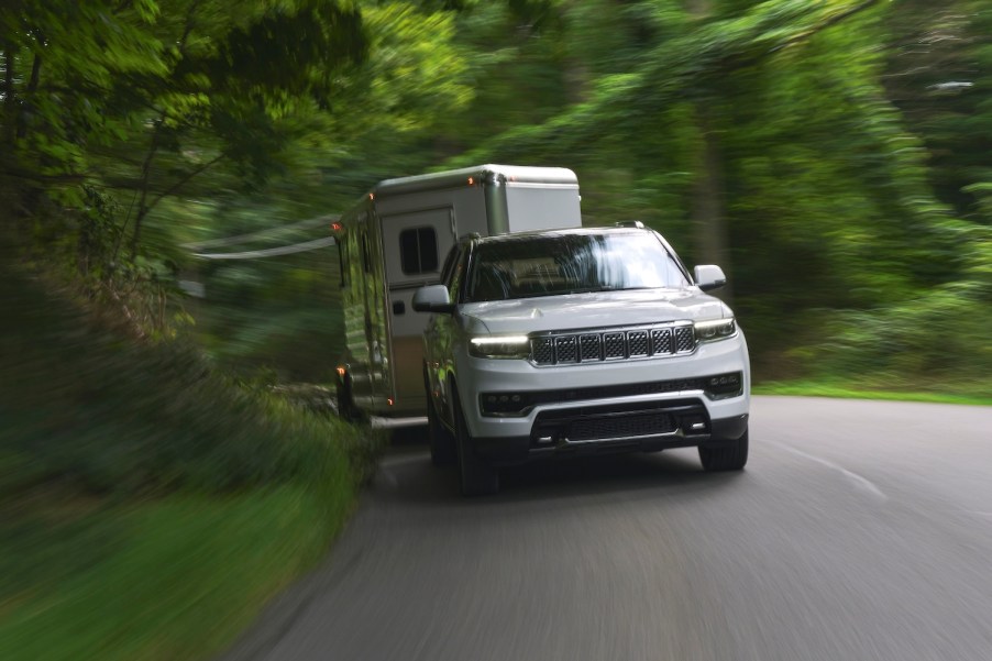 White 2022 Grand Wagoneer from Jeep towing a horse trailer