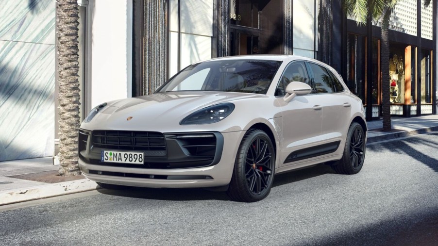 A sand-colored 2022 Porsche Macan parked in the city.