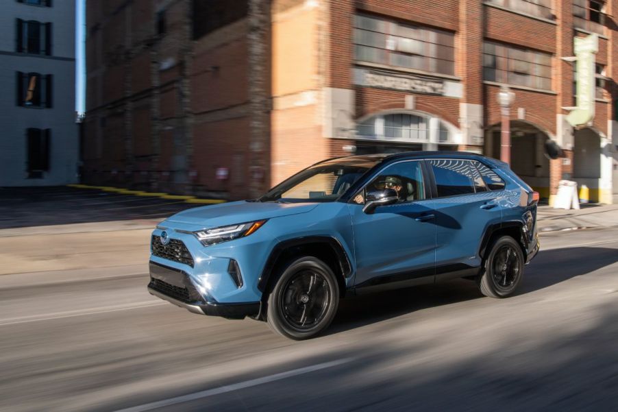 A 2022 Toyota RAV4 driving down a city street.