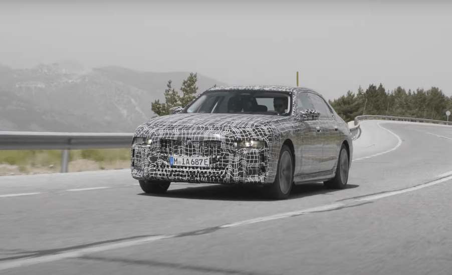 2023 BMW i7, the next-generation all-electric 7 Series, driving on a mountain road