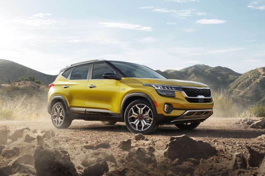 Starbright Yellow 2022 Kia Seltos parked near a pile of rocks