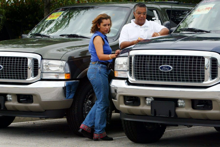 A customer has her car appraised by a dealership